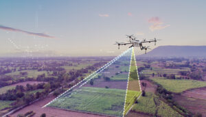 A drone hovers above, conducting a land survey with precision. The advanced technology captures a detailed aerial view, emphasizing the role of drones in modern land surveying.
